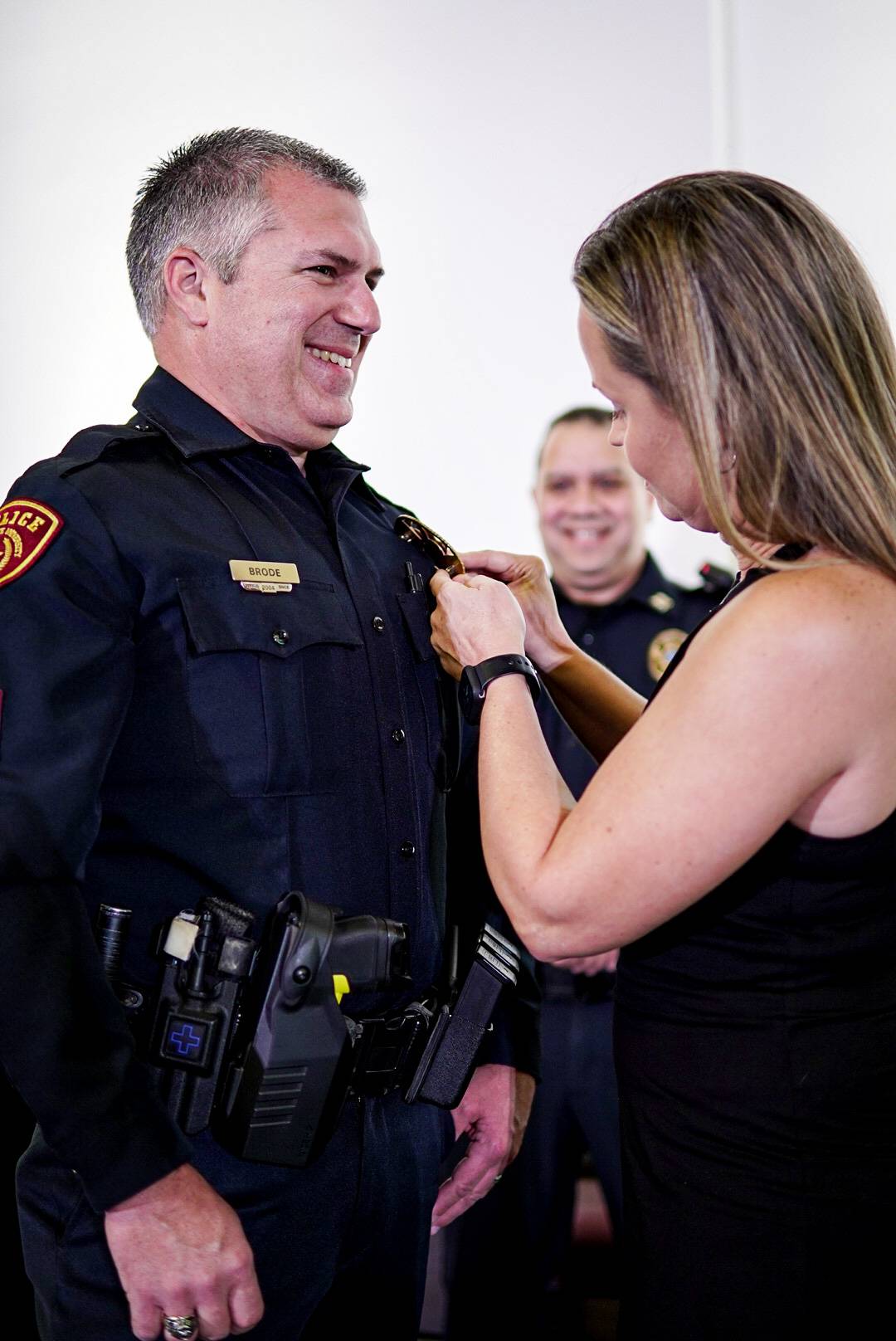 woman pinning pin on man